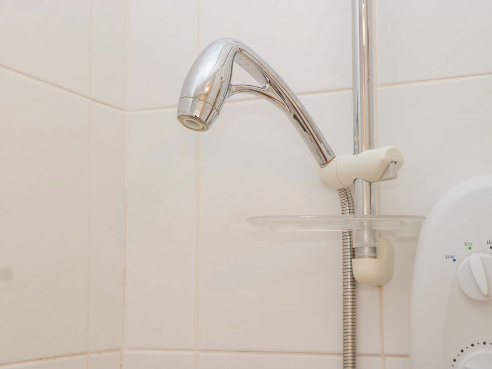 A showerhead and control unit in a bathroom at Halsdon Avenue Exmouth