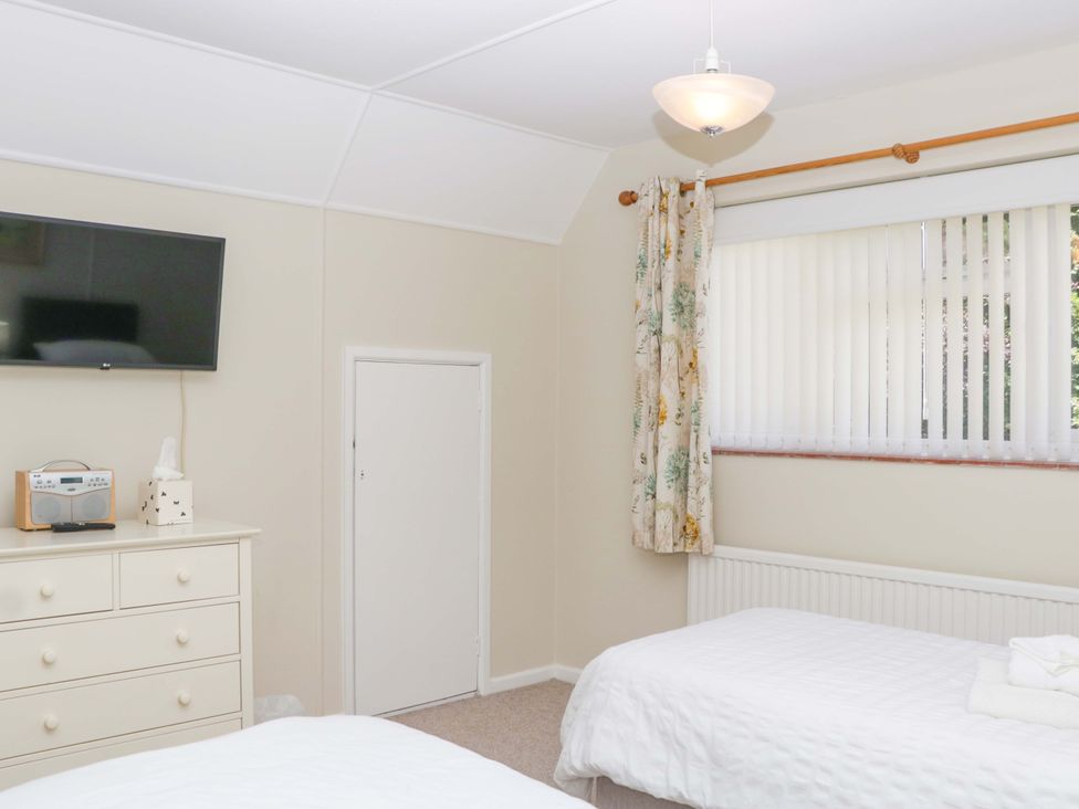 A bedroom with two beds and a television at Halsdon Avenue, Exmouth