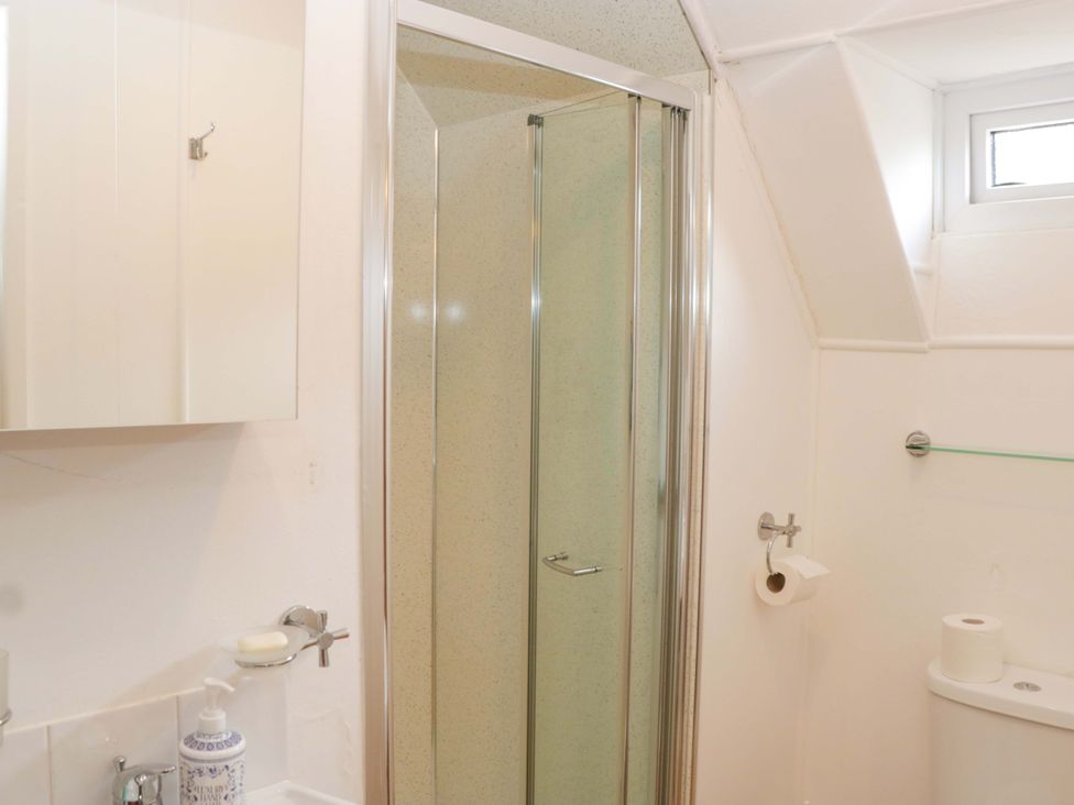 A bathroom featuring a shower, sink, and toilet at Halsdon Avenue in Exmouth