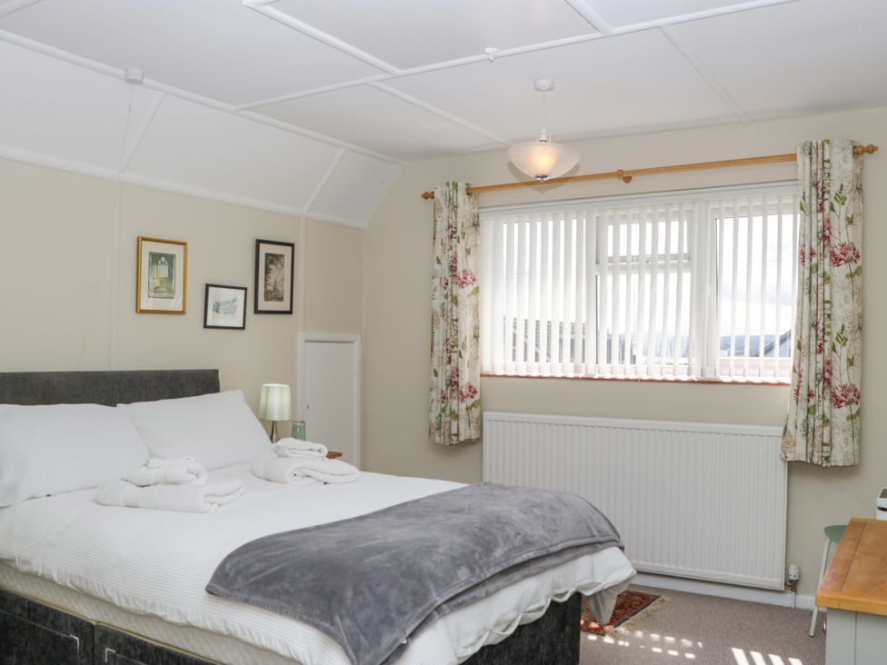 A bedroom with a bed and window at Halsdon Avenue Exmouth