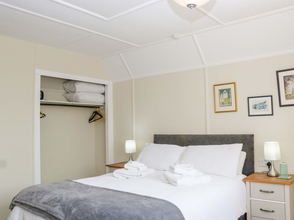 A bedroom with a bed and closet at Halsdon Avenue, Exmouth