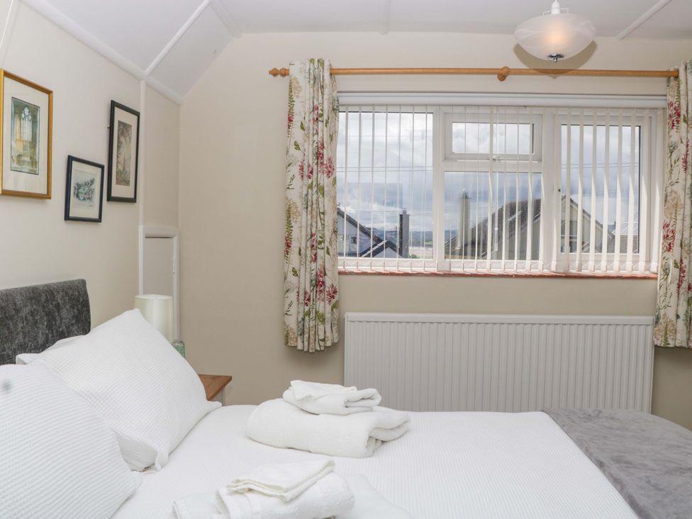 A bedroom with a bed and window at Halsdon Avenue in Exmouth