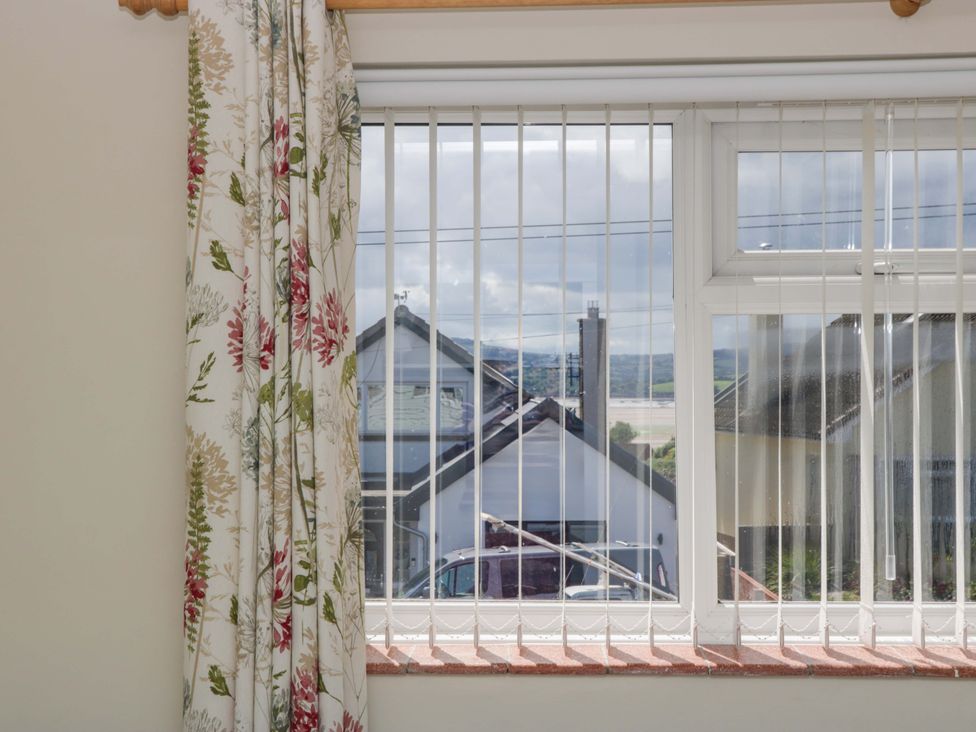 A window with a view of houses and landscape at Halsdon Avenue in Exmouth