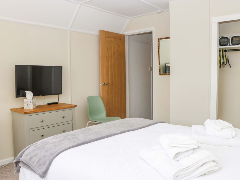 A bedroom with a bed and TV at Halsdon Avenue in Exmouth