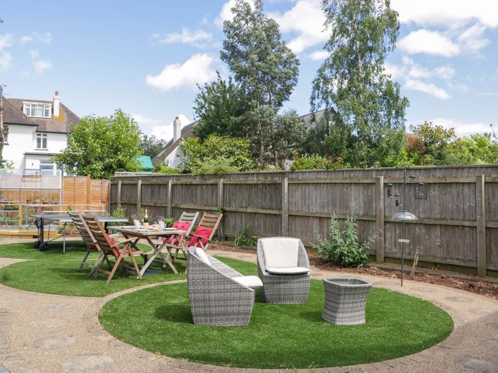 A garden with seating and dining table at Halsdon Avenue in Exmouth