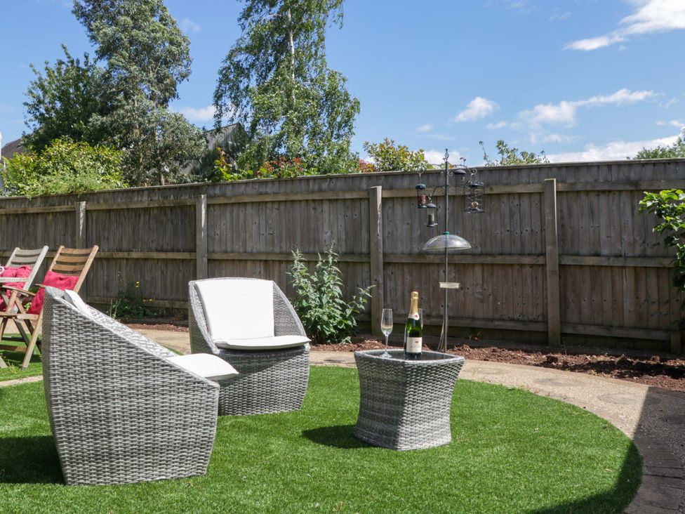 A garden with chairs and a table in Halsdon Avenue Exmouth