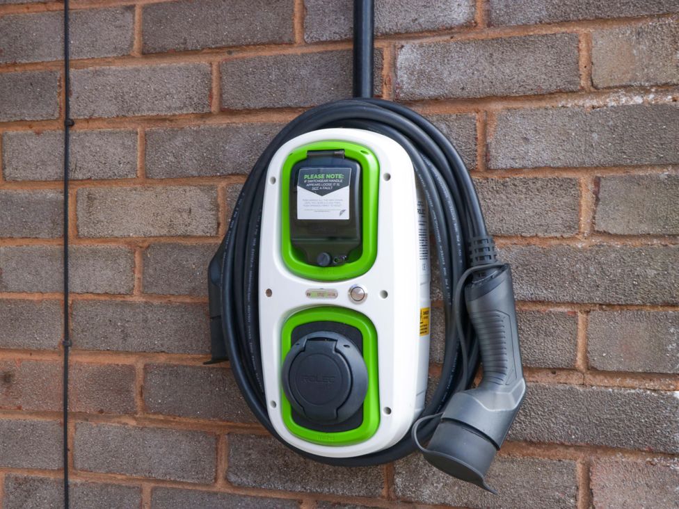 An electric vehicle charging station mounted on a wall at Halsdon Avenue in Exmouth