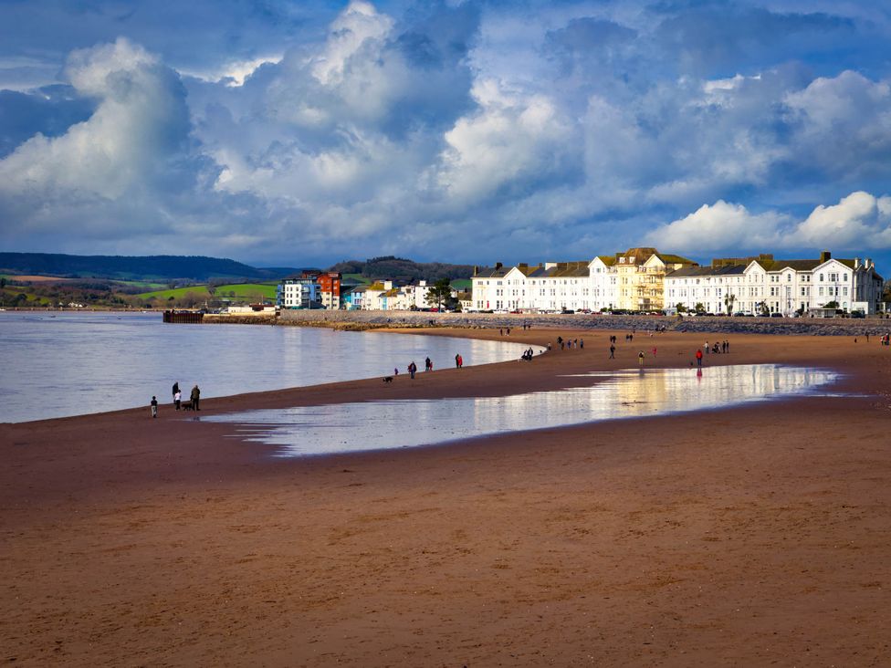 A beach with water and buildings in the background at Halsdon Avenue, Exmouth