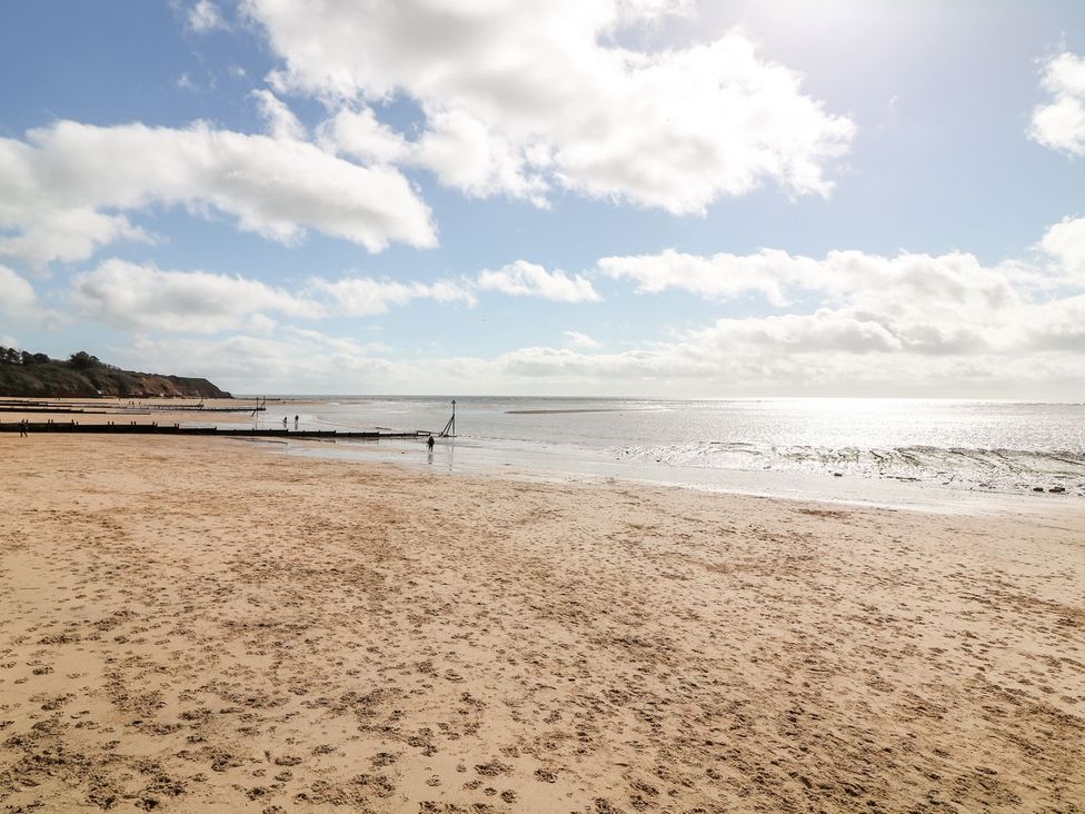 A beach with sand and water at Halsdon Avenue in Exmouth