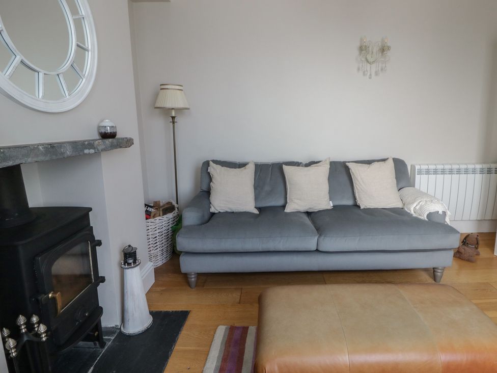 A living room with a sofa and coffee table at Arosfa in New Quay
