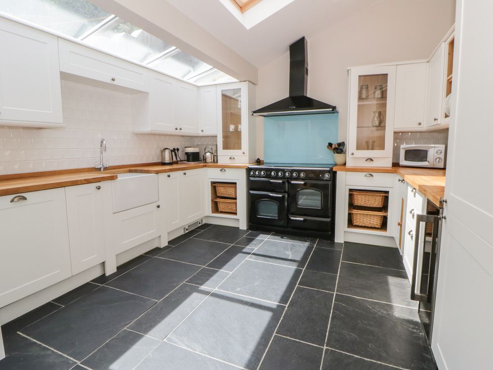 A kitchen with a sink and oven at Arosfa New Quay