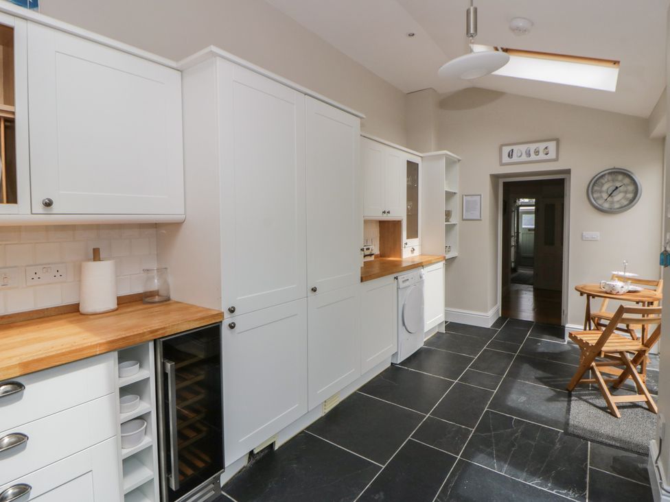 A kitchen with cabinets and a countertop at Arosfa in New Quay