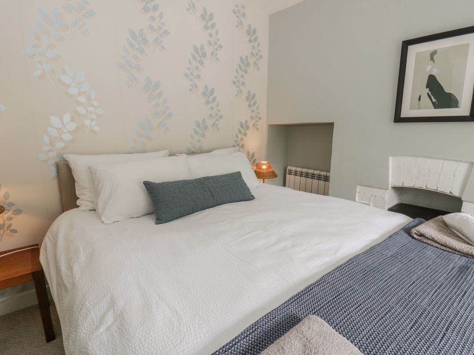 A bedroom with a bed and lamp at Arosfa New Quay