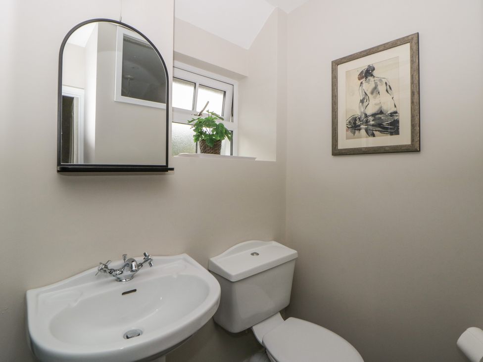 A bathroom with a sink and toilet at Arosfa in New Quay