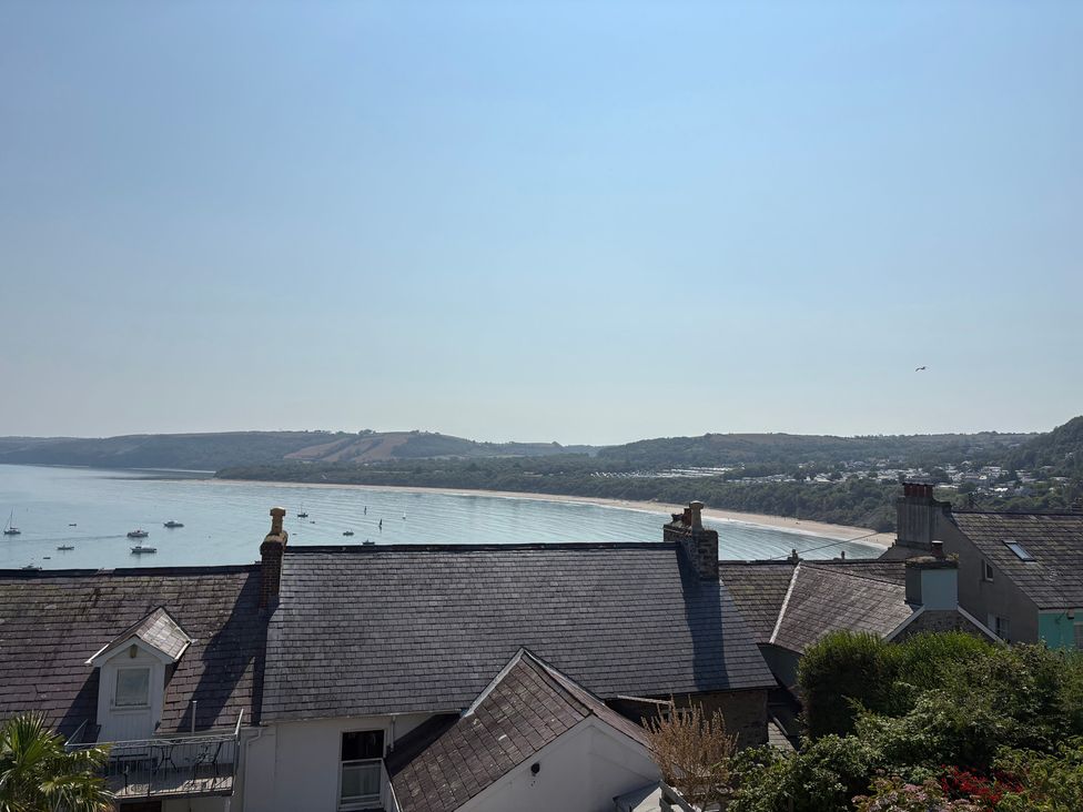 A view of the sea and beach with boats at Arosfa New Quay