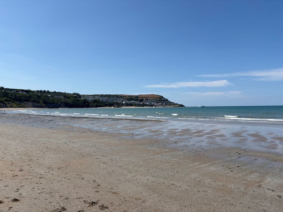 A beach with sand and water at Arosfa New Quay