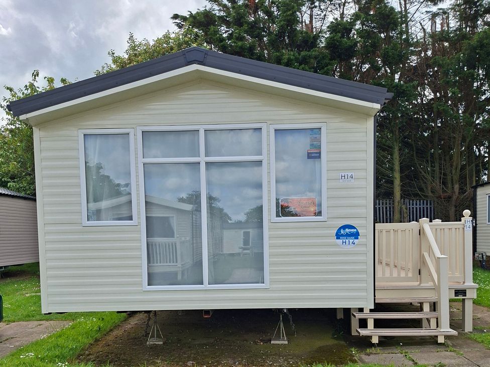 A cabin with windows and a deck at Primrose Valley, Amara's Retreat Filey