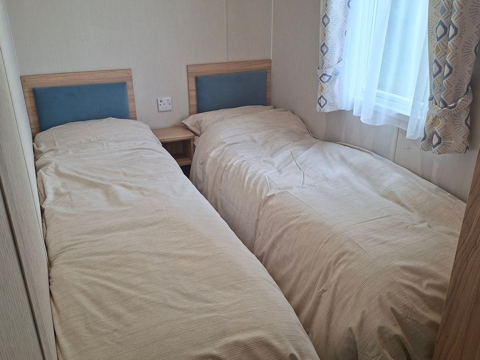 A bedroom with two single beds at Primrose Valley, Amara's Retreat in Filey