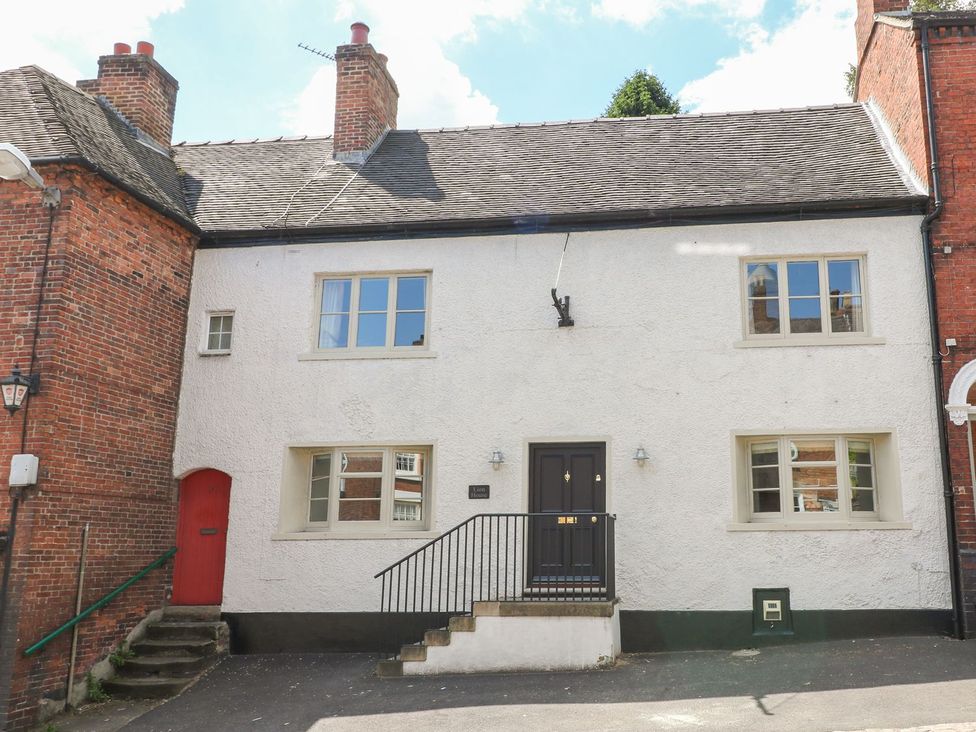 A house with a black door and red accents at Lion House in Ashbourne