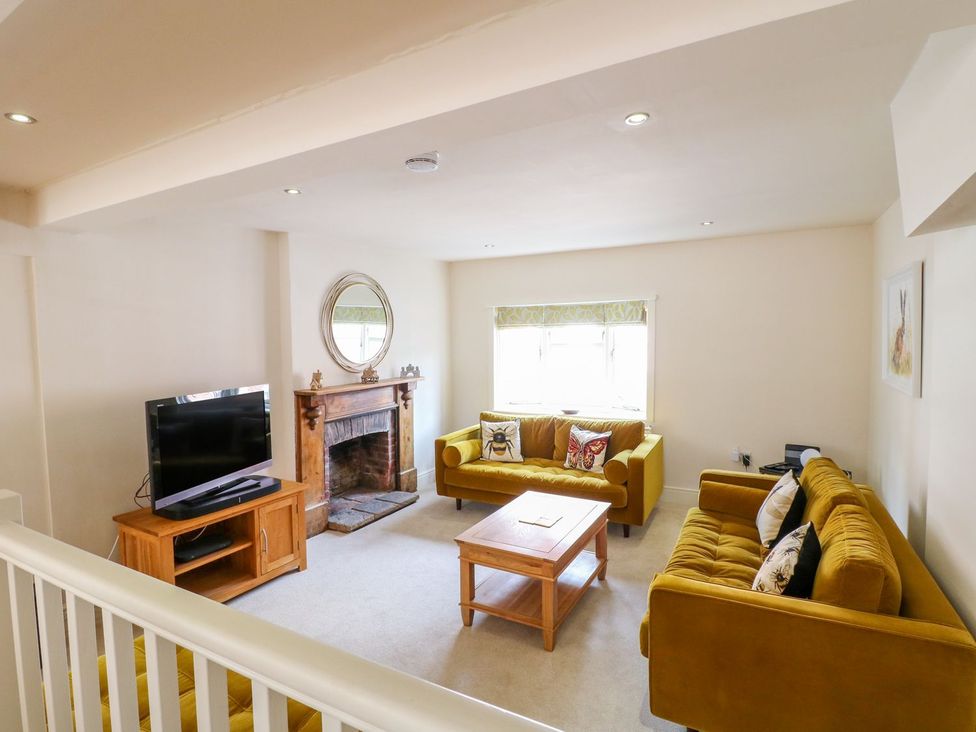 A living room with a television and a sofa at Lion House in Ashbourne