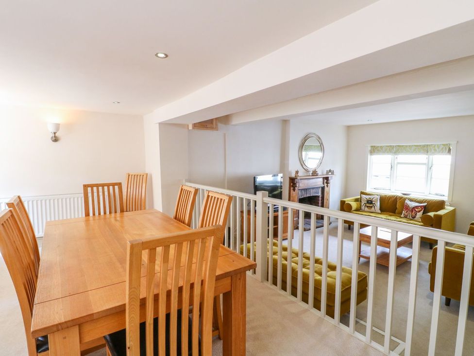 A dining room with a wooden table and chairs at Lion House in Ashbourne