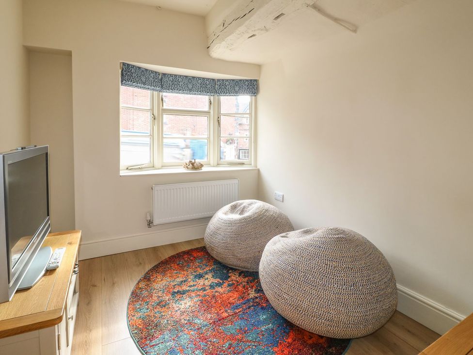 A living room with a television and beanbags at Lion House in Ashbourne