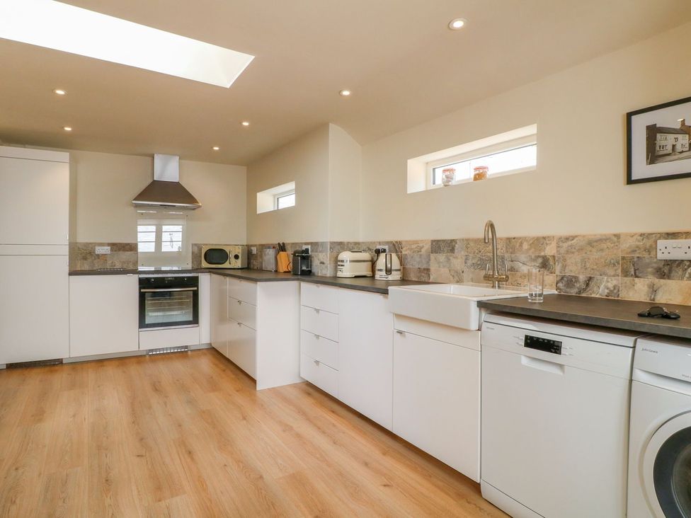 A kitchen with appliances and a work surface at Lion House in Ashbourne