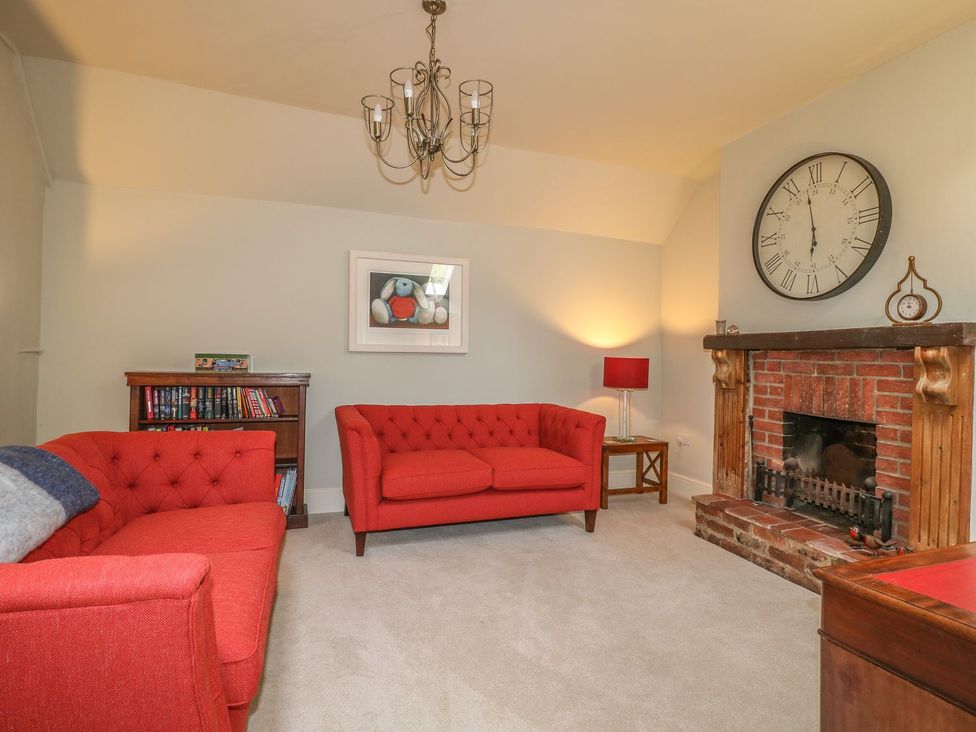 A living room with sofas and a fireplace at Lion House in Ashbourne