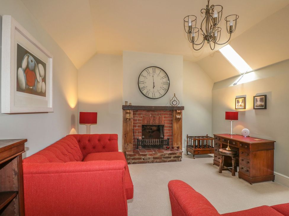 A living room with a fireplace and sofa at Lion House in Ashbourne