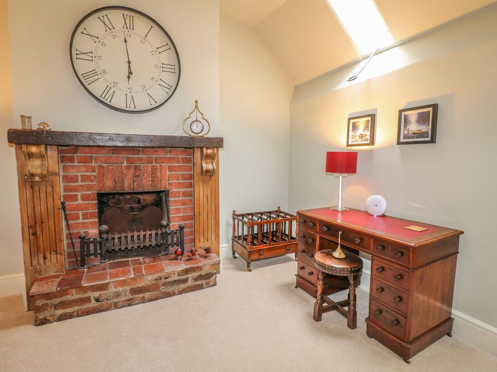 A study with a desk and lamp at Lion House in Ashbourne