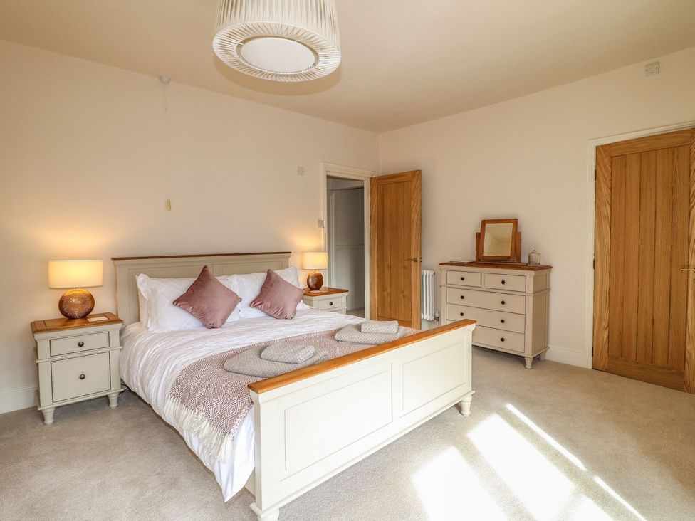 A bedroom with a bed and nightstands at Lion House in Ashbourne