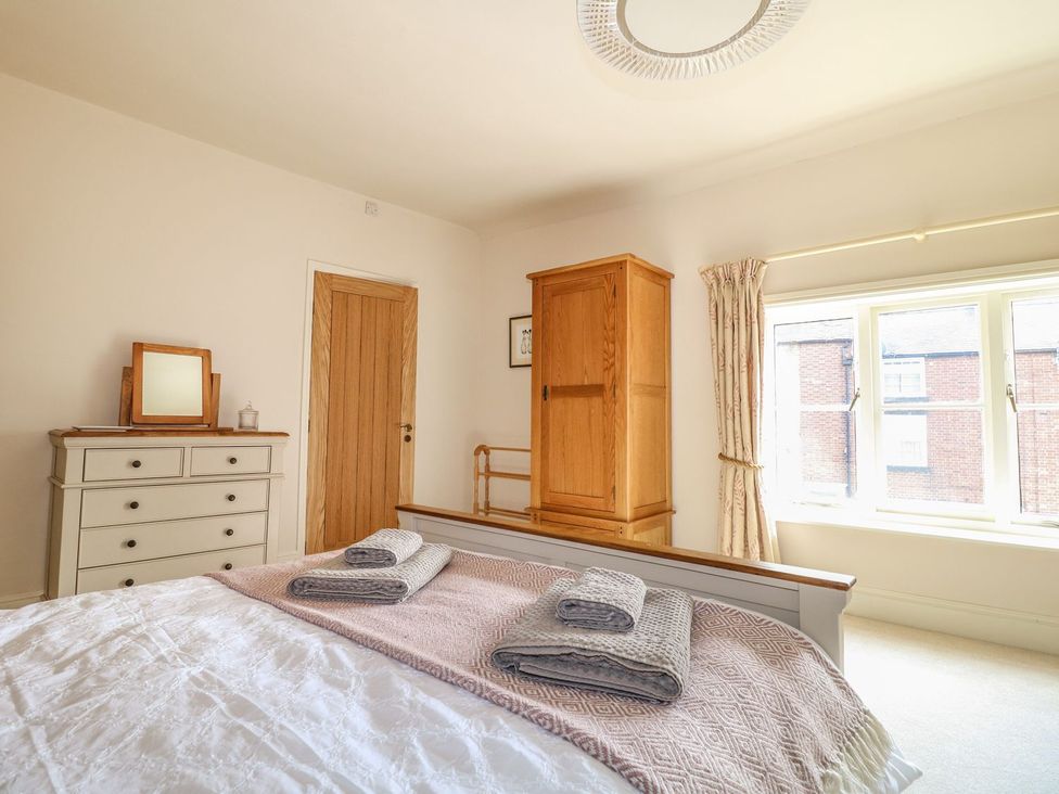 A bedroom with a bed and dresser at Lion House in Ashbourne