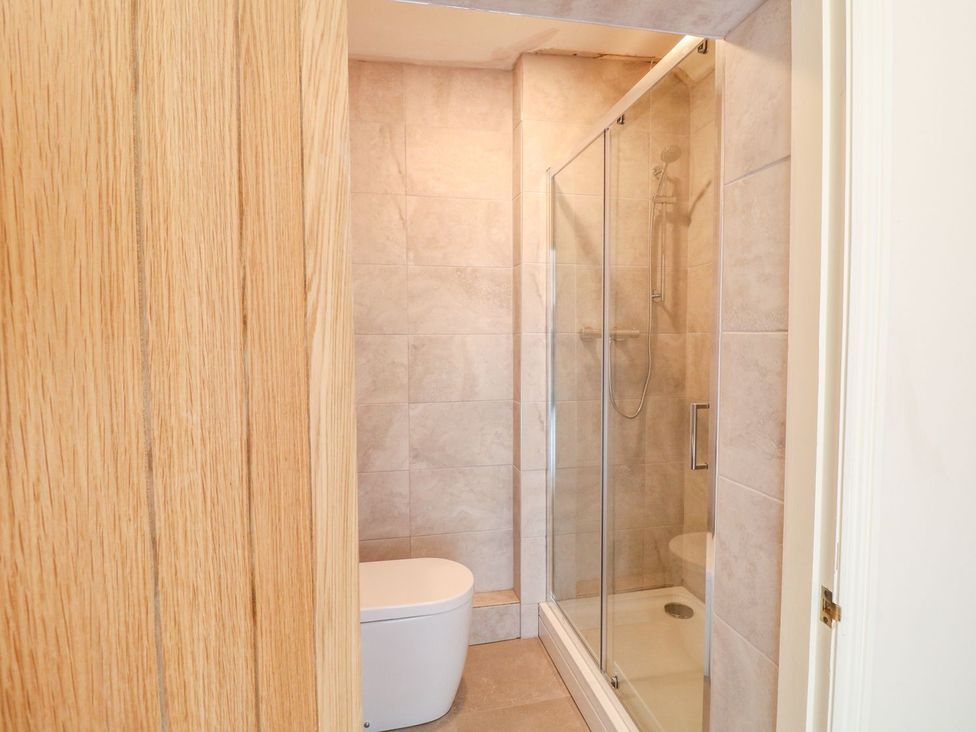A bathroom with a shower and toilet at Lion House in Ashbourne