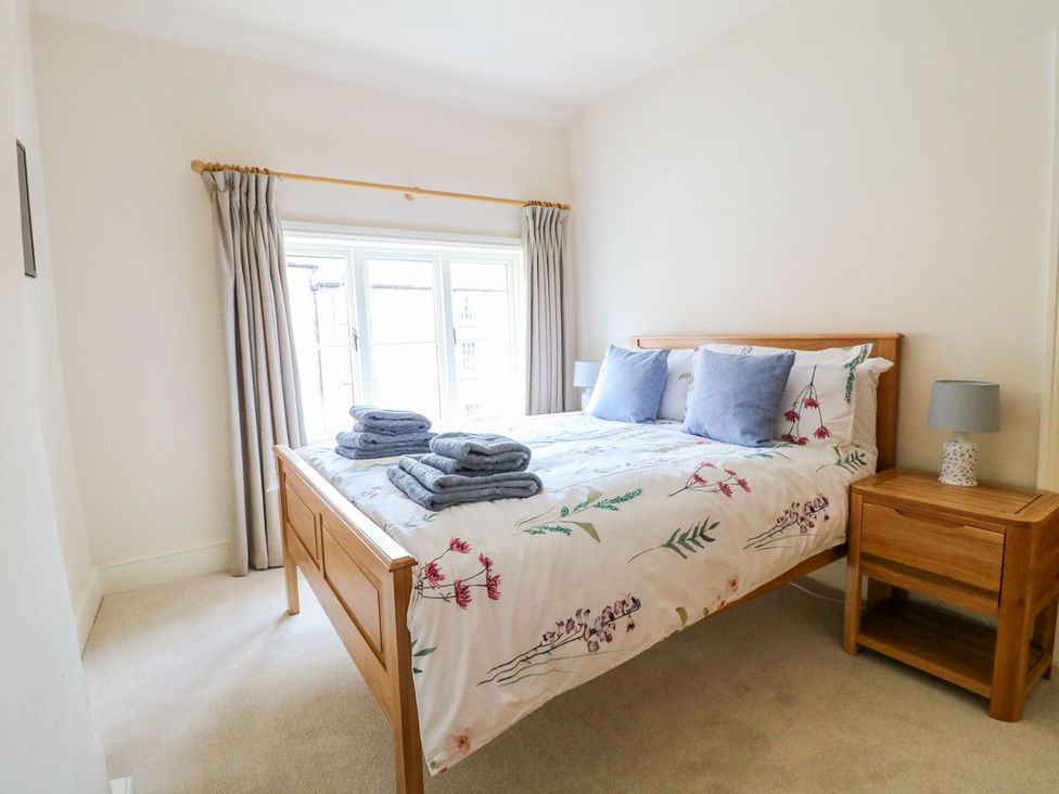 A bedroom with a bed and side table at Lion House in Ashbourne