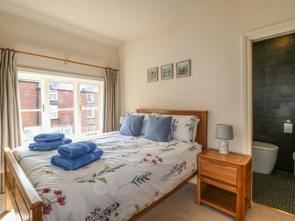 A bedroom with a bed and window at Lion House in Ashbourne