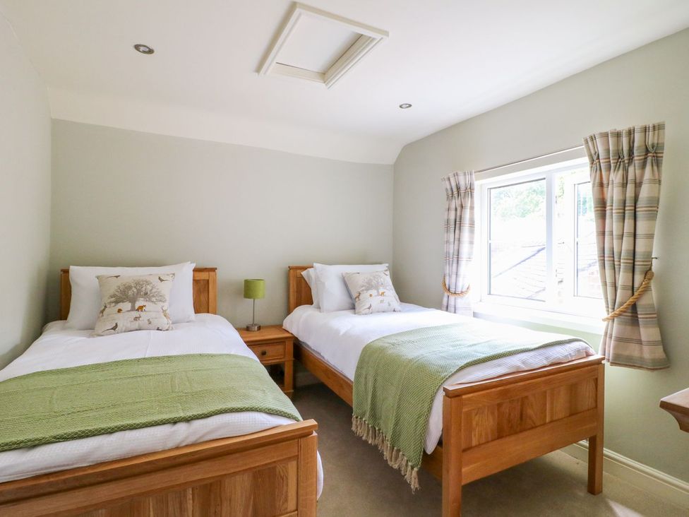 A bedroom with two beds and a window at Lion House in Ashbourne