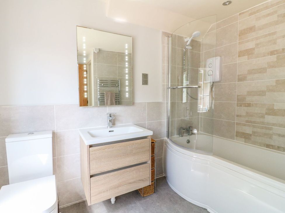 A bathroom with a sink and bathtub at Lion House in Ashbourne