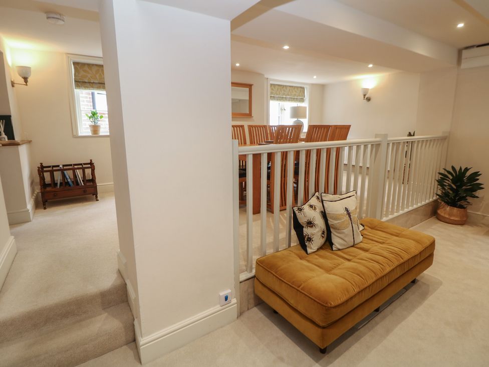 A living room with a sofa and dining area at Lion House in Ashbourne