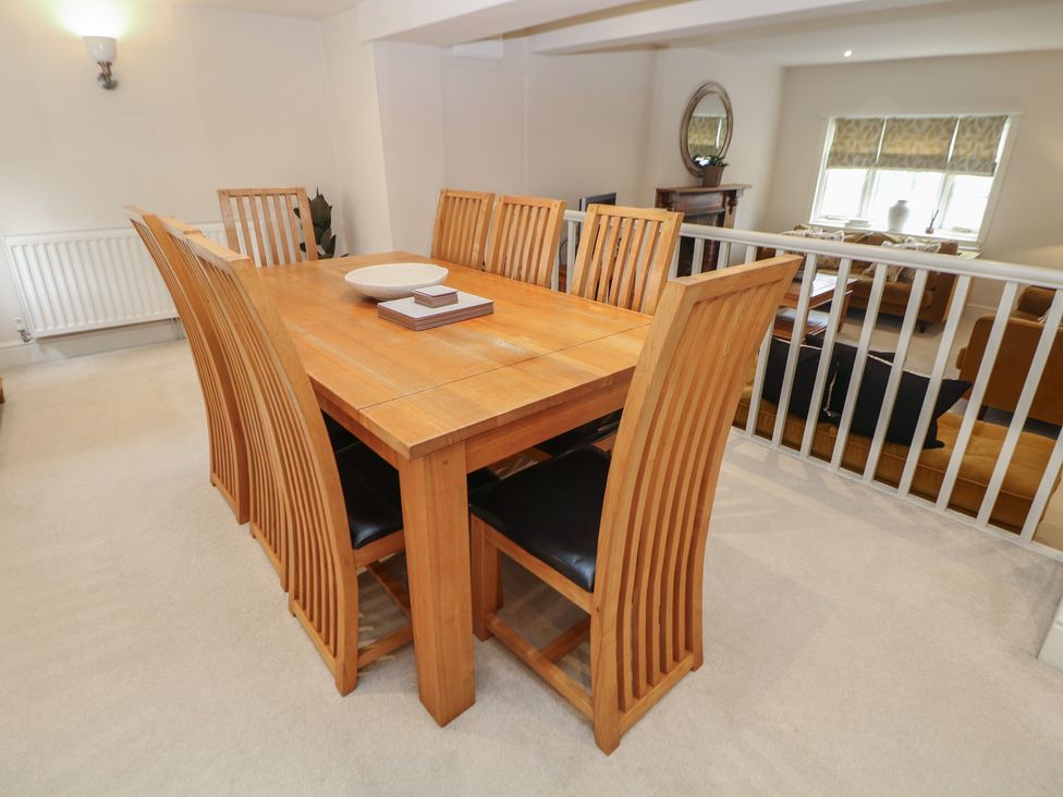 A dining room with a wooden dining table and chairs at Lion House in Ashbourne