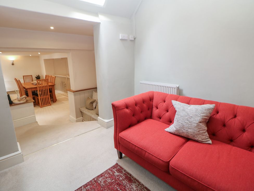 A living room with a sofa and a dining area at Lion House in Ashbourne