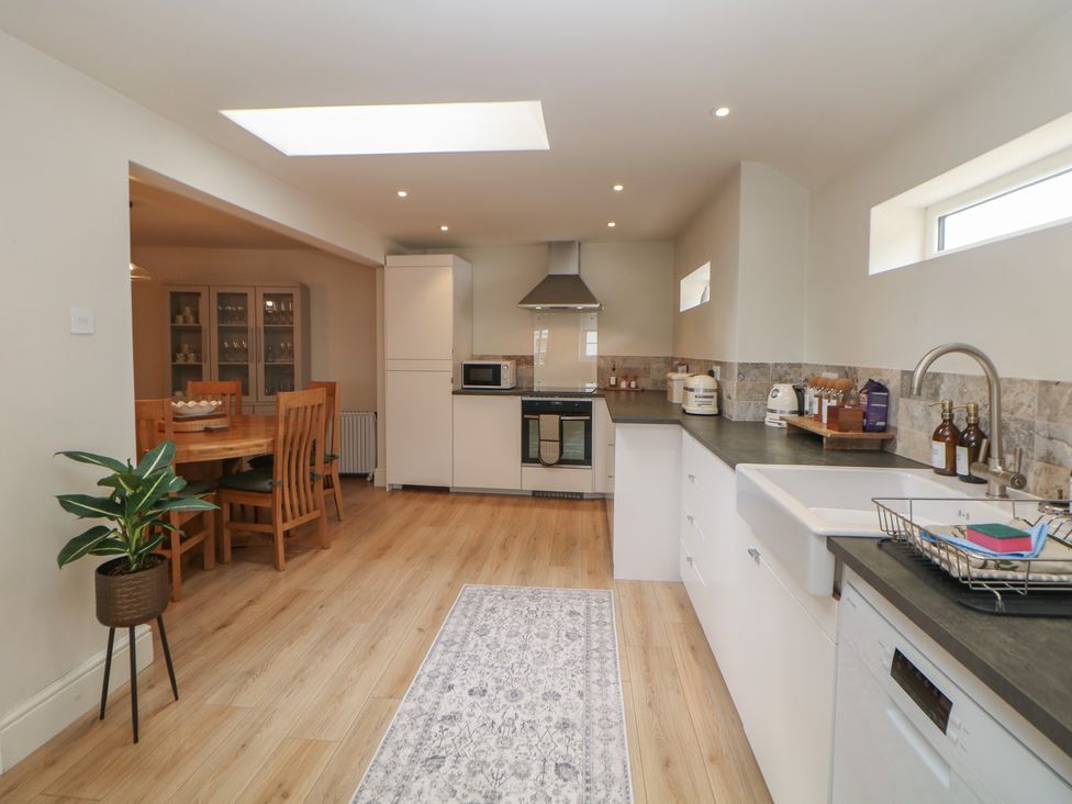 A kitchen with appliances and a dining area at Lion House in Ashbourne