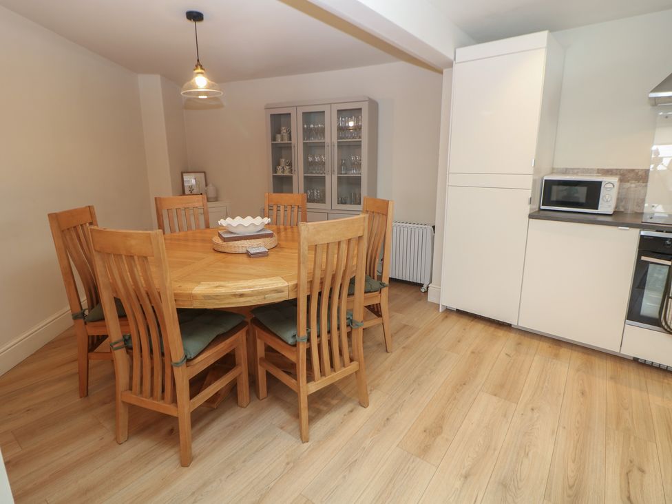 A dining room with a round table and chairs at Lion House in Ashbourne