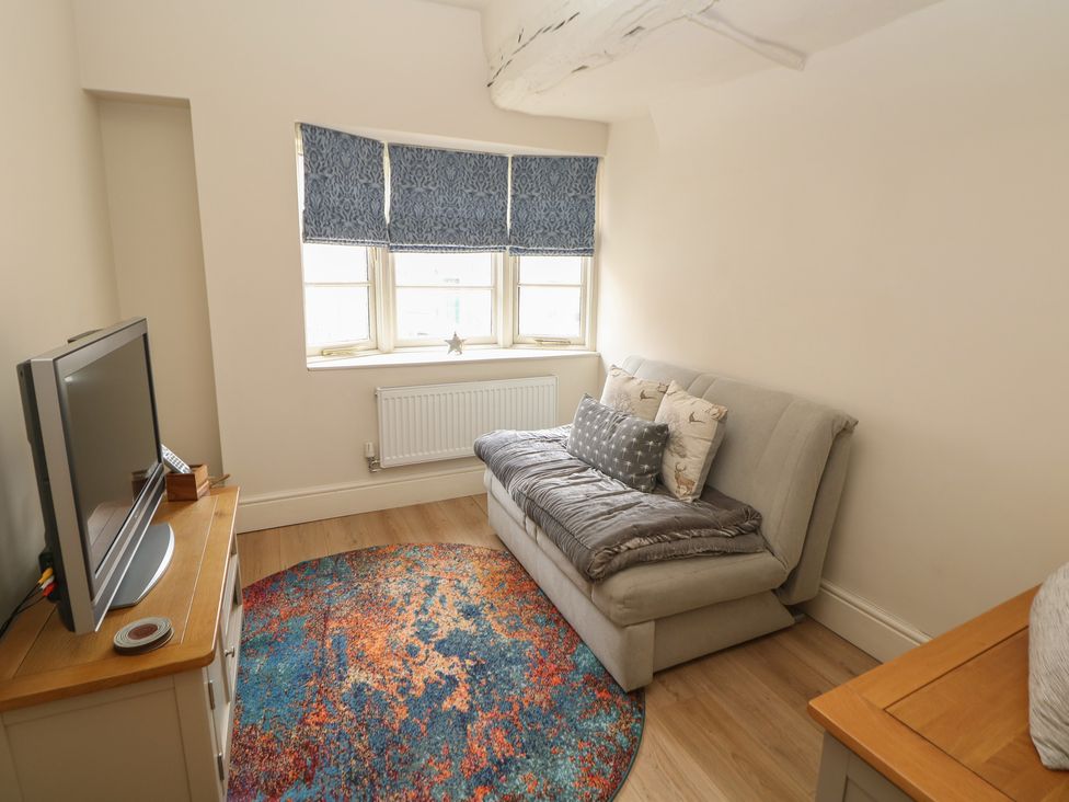 A living room with a sofa bed and television at Lion House in Ashbourne
