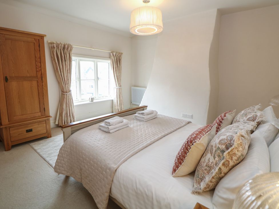A bedroom with a bed and wardrobe at Lion House in Ashbourne