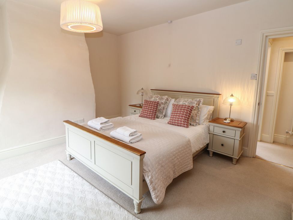 A bedroom with a bed and nightstands at Lion House in Ashbourne