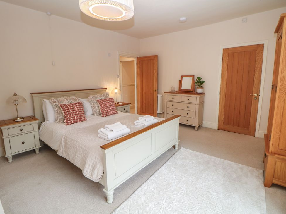 A bedroom featuring a bed with pillows and towels at Lion House in Ashbourne