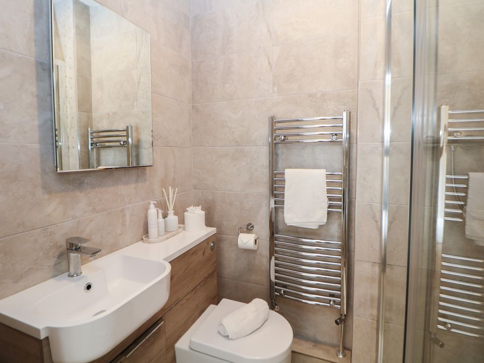 A bathroom with a sink, toilet, and shower at Lion House in Ashbourne