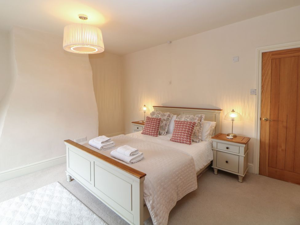 A bedroom with a bed, bedside tables and lamps at Lion House in Ashbourne