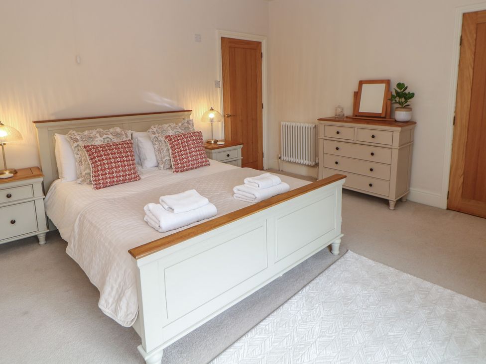 A bedroom with a bed and dresser at Lion House in Ashbourne