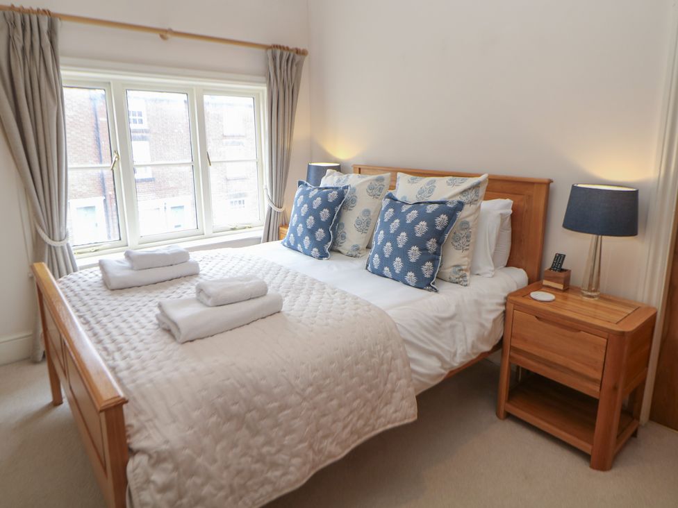 A bedroom with a bed and bedside table at Lion House Ashbourne